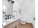 Modern bathroom featuring a marble vanity, sleek black fixtures, and a well-lit mirror, creating a spa-like atmosphere at 1027 Hosbrook St, Indianapolis, IN 46203