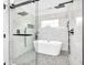 Luxurious bathroom with a freestanding tub, glass shower, and elegant tile work at 1027 Hosbrook St, Indianapolis, IN 46203