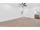 Unfurnished bedroom featuring neutral carpet, ceiling fan, and a glimpse into the attached bathroom at 1027 Hosbrook St, Indianapolis, IN 46203