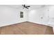Bright bedroom featuring wood-look floors, ceiling fan, and natural light from the window at 1027 Hosbrook St, Indianapolis, IN 46203