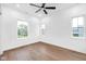 Bright bedroom with hardwood floors, a ceiling fan, and large windows at 1027 Hosbrook St, Indianapolis, IN 46203