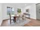 Bright dining room with a large window, wood table, and modern chairs creating an inviting dining space at 1027 Hosbrook St, Indianapolis, IN 46203