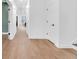 Bright hallway with wood floors and neutral walls, seamlessly connecting the home's living spaces at 1027 Hosbrook St, Indianapolis, IN 46203
