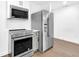 Modern kitchen equipped with stainless steel appliances and built-in microwave at 1027 Hosbrook St, Indianapolis, IN 46203