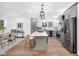 Modern kitchen with stainless steel appliances, ample cabinet space, island seating, and contemporary lighting at 1027 Hosbrook St, Indianapolis, IN 46203