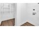 Bright laundry room with washer and dryer hookups and wire shelving at 1027 Hosbrook St, Indianapolis, IN 46203