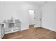 Bright mudroom features stainless steel sink, white walls and trim, and wood-look flooring at 1027 Hosbrook St, Indianapolis, IN 46203
