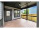 Back patio with wooden floors and ceiling, looking out to a fenced yard and neighborhood at 1027 Hosbrook St, Indianapolis, IN 46203