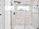 Updated shower with rainfall shower head, glass door and shelves, and large format tile at 1027 Hosbrook St, Indianapolis, IN 46203