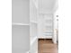 Bright walk-in closet with custom shelving and hardwood floors provides ample storage at 1027 Hosbrook St, Indianapolis, IN 46203