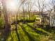 Backyard featuring mature trees, a lush lawn, and a well-maintained deck at 10759 Sawgrass Dr, Fishers, IN 46037