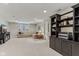 Finished basement featuring a neutral toned sofa, black entertainment center, and built in shelving at 10759 Sawgrass Dr, Fishers, IN 46037