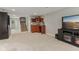 Basement area with a wet bar, staircase, and TV setup at 10759 Sawgrass Dr, Fishers, IN 46037