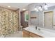Neutral toned bathroom featuring a shower and tub with floral curtain and light wood vanity at 10759 Sawgrass Dr, Fishers, IN 46037