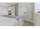 Bright bedroom featuring a comfortable bed, closet, and view to an exercise room at 10759 Sawgrass Dr, Fishers, IN 46037