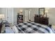 This bedroom includes a bookcase, large dresser and a view of an open doorway at 10759 Sawgrass Dr, Fishers, IN 46037
