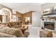Open-concept living space with a cozy fireplace, dining area, and comfortable seating at 10759 Sawgrass Dr, Fishers, IN 46037