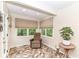 Cozy sunroom with tile floors, natural light, and a comfortable chair, creating a peaceful retreat at 10759 Sawgrass Dr, Fishers, IN 46037
