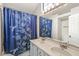 Bright bathroom featuring a double sink vanity, a large mirror, and a shower with a decorative blue curtain at 11072 Lake Run Dr, Fishers, IN 46038