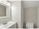 Cozy bathroom featuring a white sink and toilet with simple, neutral décor at 11072 Lake Run Dr, Fishers, IN 46038