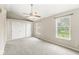 A bedroom with neutral walls, carpeted floors, closet and windows offers ample natural light at 11072 Lake Run Dr, Fishers, IN 46038