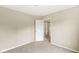 Neutral-toned, carpeted bedroom showcasing closet doors and an open door to another room at 11072 Lake Run Dr, Fishers, IN 46038