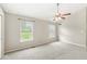 Bright carpeted bedroom features natural light and a ceiling fan at 11072 Lake Run Dr, Fishers, IN 46038