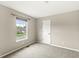 A carpeted bedroom provides neutral walls with a sunny window and ample square footage at 11072 Lake Run Dr, Fishers, IN 46038