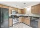 Functional kitchen featuring wood cabinets, black appliances, a stainless steel oven, and a black countertop at 11072 Lake Run Dr, Fishers, IN 46038