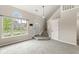 Inviting living room with a large window, a half-moon window above it, stairs to the second floor, and neutral tones at 11072 Lake Run Dr, Fishers, IN 46038