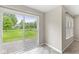 Bright room featuring sliding glass doors that open to the backyard, as well as an additional window with blinds at 11072 Lake Run Dr, Fishers, IN 46038