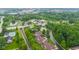 Aerial view of a community featuring homes, ponds, and green spaces, showcasing a blend of residential and recreational amenities at 11510 Monon Farms Ln, Carmel, IN 46032