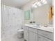 Well-lit bathroom featuring a shower-tub combo and a white vanity with ample counter space at 11510 Monon Farms Ln, Carmel, IN 46032