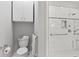 Bright bathroom with modern toilet and shower featuring elegant white subway tile and shower shelves at 11510 Monon Farms Ln, Carmel, IN 46032