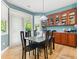 Light-filled dining area with wood floors, a modern light fixture, and a sliding door to the backyard at 11510 Monon Farms Ln, Carmel, IN 46032