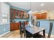 Dining area featuring wood floors, modern light fixture, and built-in cabinets for extra storage at 11510 Monon Farms Ln, Carmel, IN 46032