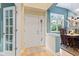 Welcoming foyer with hardwood floors and a view of the dining area at 11510 Monon Farms Ln, Carmel, IN 46032