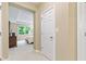 Hallway view of the home showing bedroom with natural light and tray ceiling at 11510 Monon Farms Ln, Carmel, IN 46032