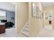 Inviting hallway and staircase with decorative art leading to a bright office space at 11510 Monon Farms Ln, Carmel, IN 46032
