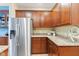 Kitchen featuring stainless steel refrigerator, wood cabinets, and granite countertops at 11510 Monon Farms Ln, Carmel, IN 46032