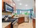 Modern kitchen boasts granite countertops, stainless steel appliances, and hardwood floors at 11510 Monon Farms Ln, Carmel, IN 46032