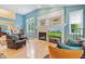 Bright, open living room with hardwood floors, fireplace, and large windows offering plenty of natural light at 11510 Monon Farms Ln, Carmel, IN 46032