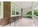 Charming porch with brick siding, offering a cozy spot to relax outdoors at 11510 Monon Farms Ln, Carmel, IN 46032