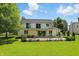 Charming backyard with a covered patio, lush lawn and manicured landscaping at 1240 Stringtown Pike, Cicero, IN 46034