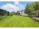 Large backyard featuring lush green grass, plenty of room for fun, and a covered patio for entertaining at 1240 Stringtown Pike, Cicero, IN 46034