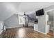 Spacious bonus room featuring wood flooring, stainless appliances, and a utility sink at 1240 Stringtown Pike, Cicero, IN 46034