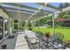 Inviting covered patio with outdoor seating, perfect for relaxing and entertaining with views of the backyard at 1240 Stringtown Pike, Cicero, IN 46034