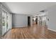 Open concept living room with wood floors leading to the kitchen and access to the backyard at 1240 Stringtown Pike, Cicero, IN 46034
