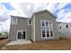 This new construction home features a sliding glass door and several windows at 12403 Fresh Stock Dr, Noblesville, IN 46060