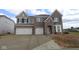 New brick home showcasing a spacious driveway and an attached two-car garage at 12403 Fresh Stock Dr, Noblesville, IN 46060
